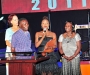 Omega Bugembe Okello, middle, after receiving her award, with her father and mother, at the Diaspora Dinner held at the Serena Victoria Ballroom on Thursday. PHOTO BY KALUNGI KABUYE