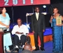 Dr Sarah Matovu, right, accepting her award at the Diaspora Dinner held at the Serena Victoria Ballroom on Thursday. In the wheelchair is her husband, Dr Matovu. PHOTO BY KALUNGI KABUYE